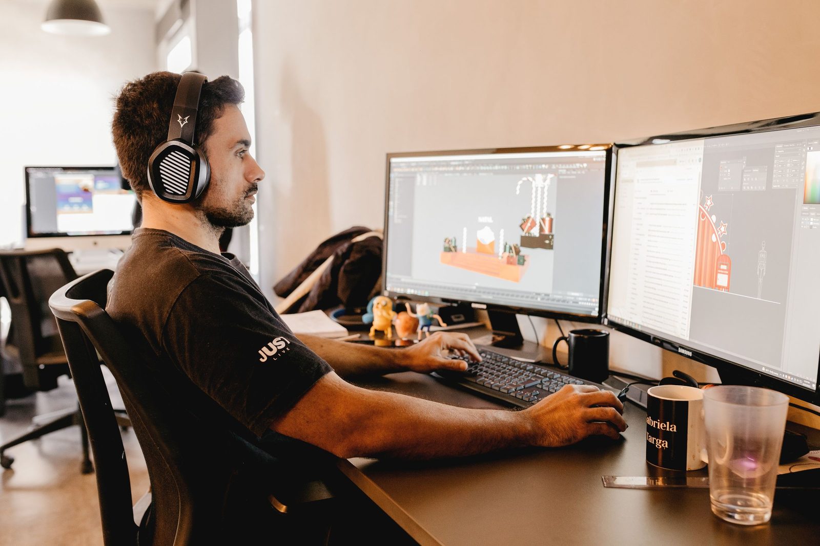 A developer building 3D game content across a multi-monitor workstation