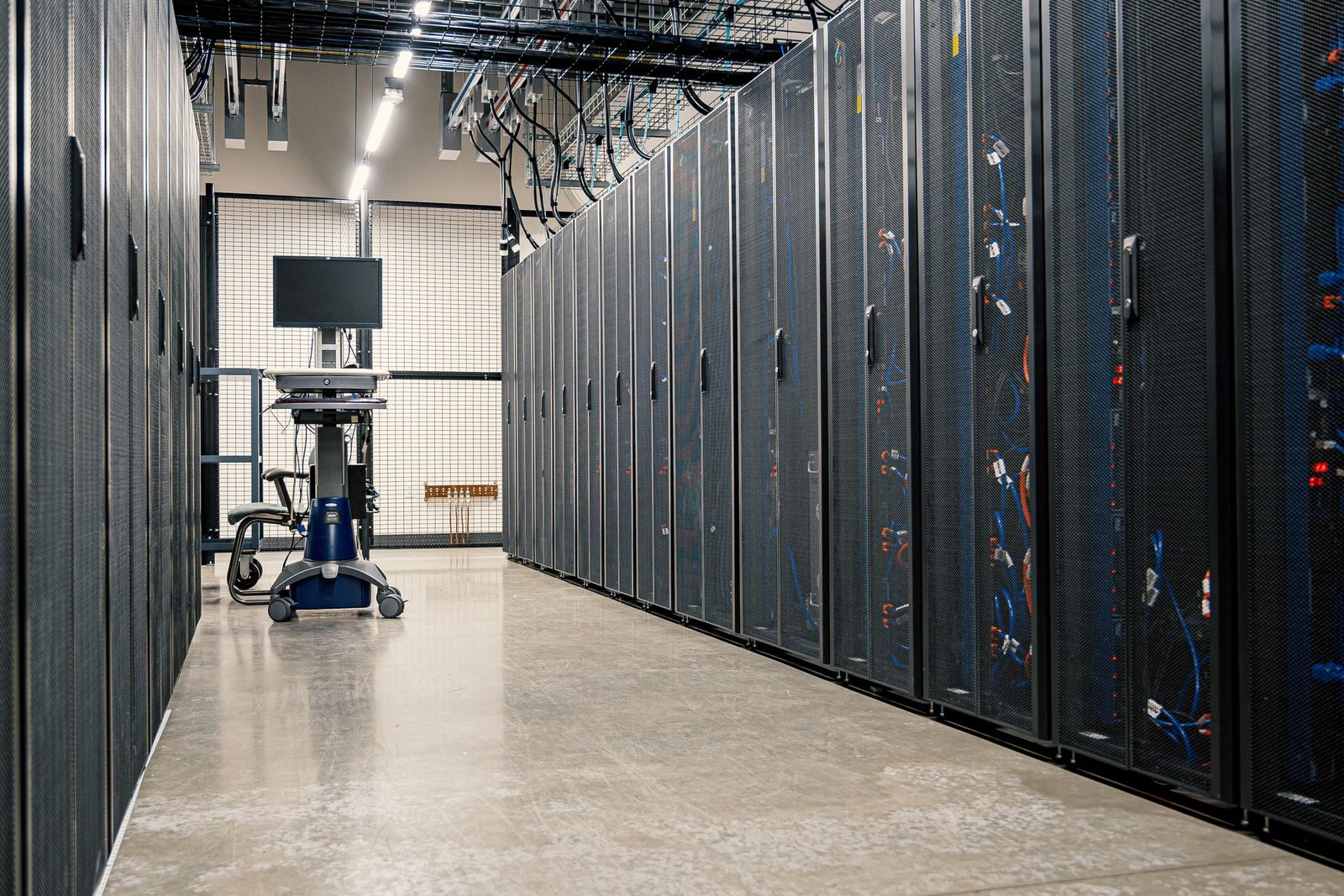 An aisle of server racks in an on-premise data centre