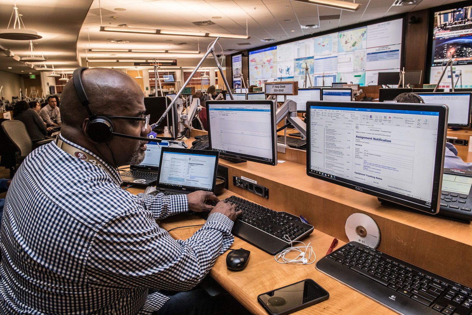 An operator working a multi-monitor position — the kind of daily workflow a line-of-business system has to survive